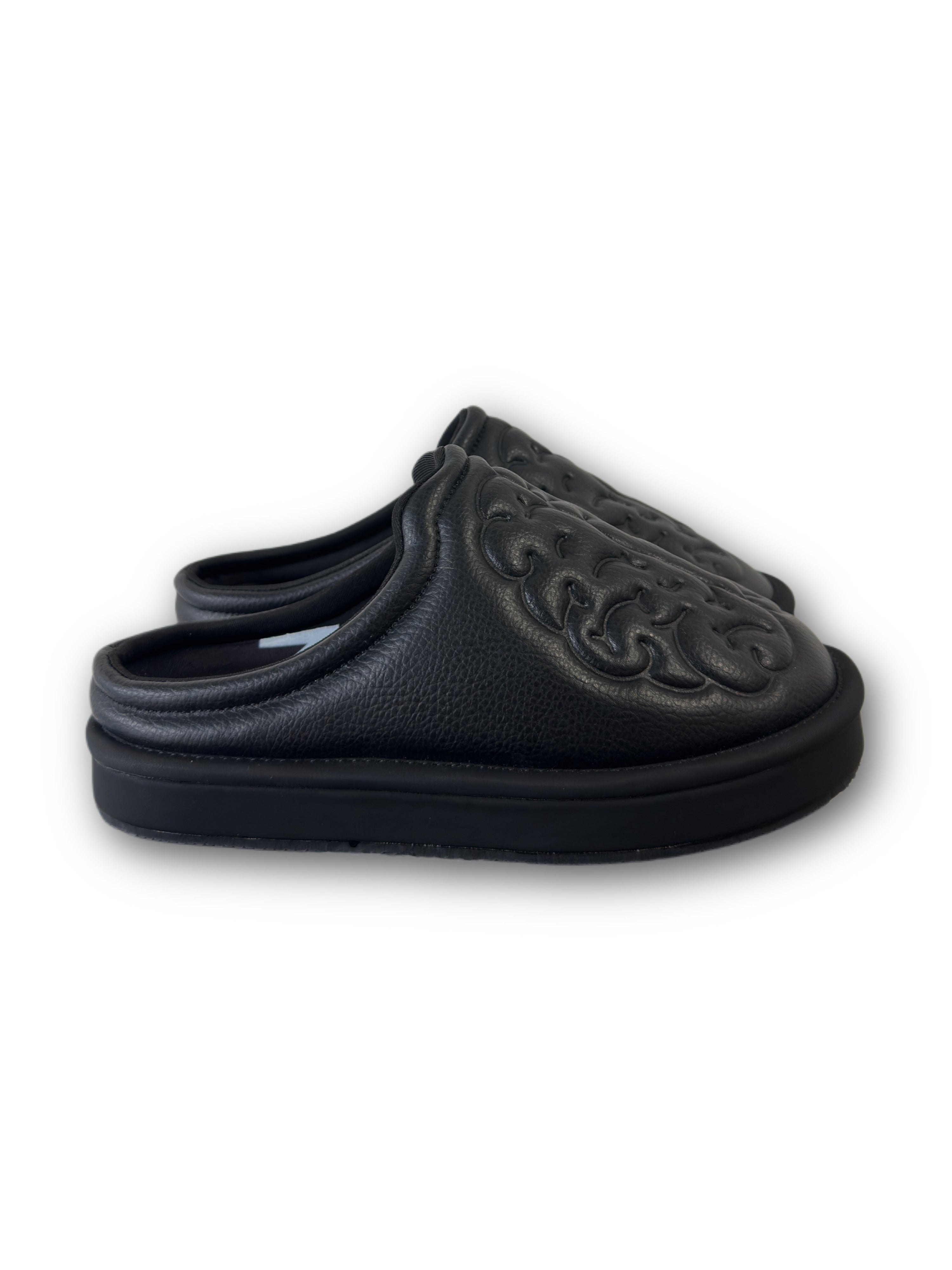 Black leather shoes with brain embossed design on a white background side view