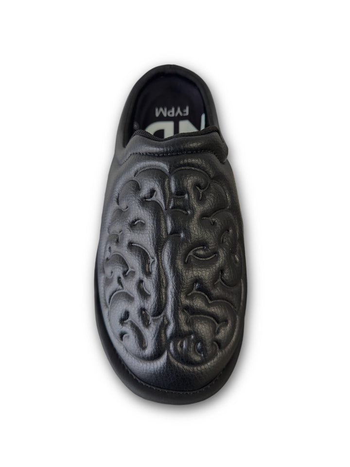 Black leather shoe with brain embossed design on a white background top view