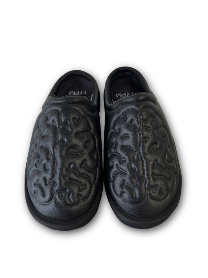Black leather shoes with brain embossed design on a white background top view